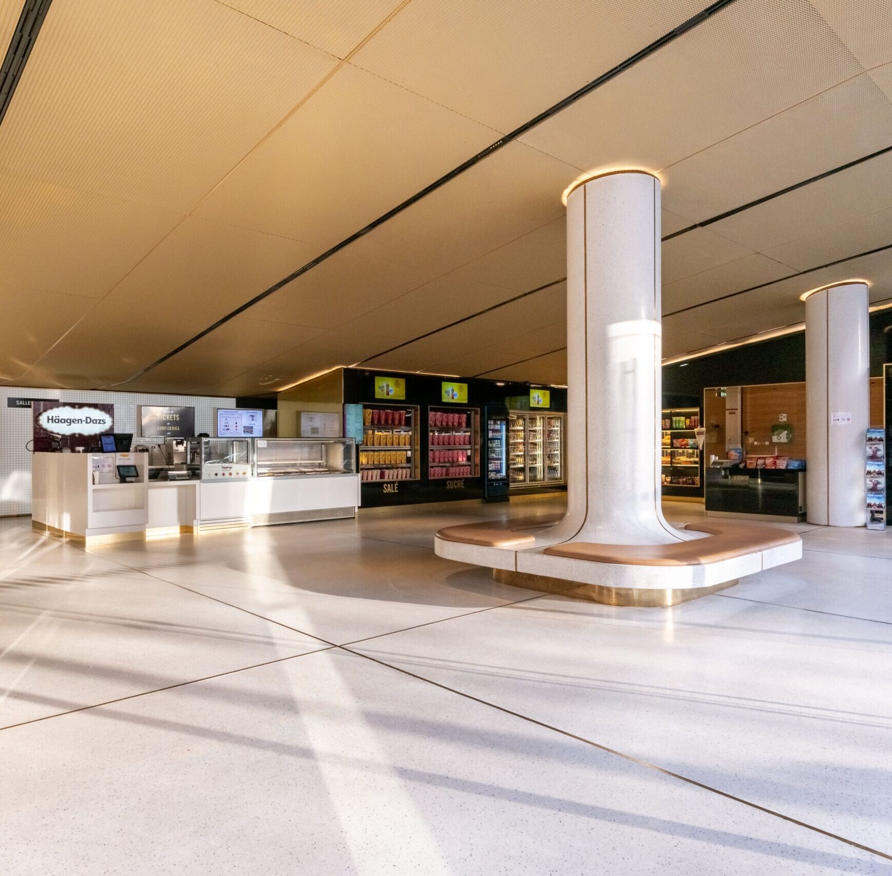 Grand espace de réception situé dans le hall du cinéma, baigné de lumière naturelle grâce à ses grandes baies vitrées.